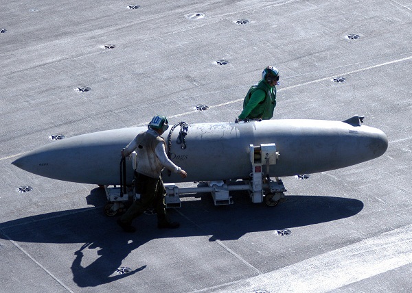 A 330 US gallons (1,200 L) Sargent Fletcher drop tank being moved across the flight deck of an Aircraft carrier. 